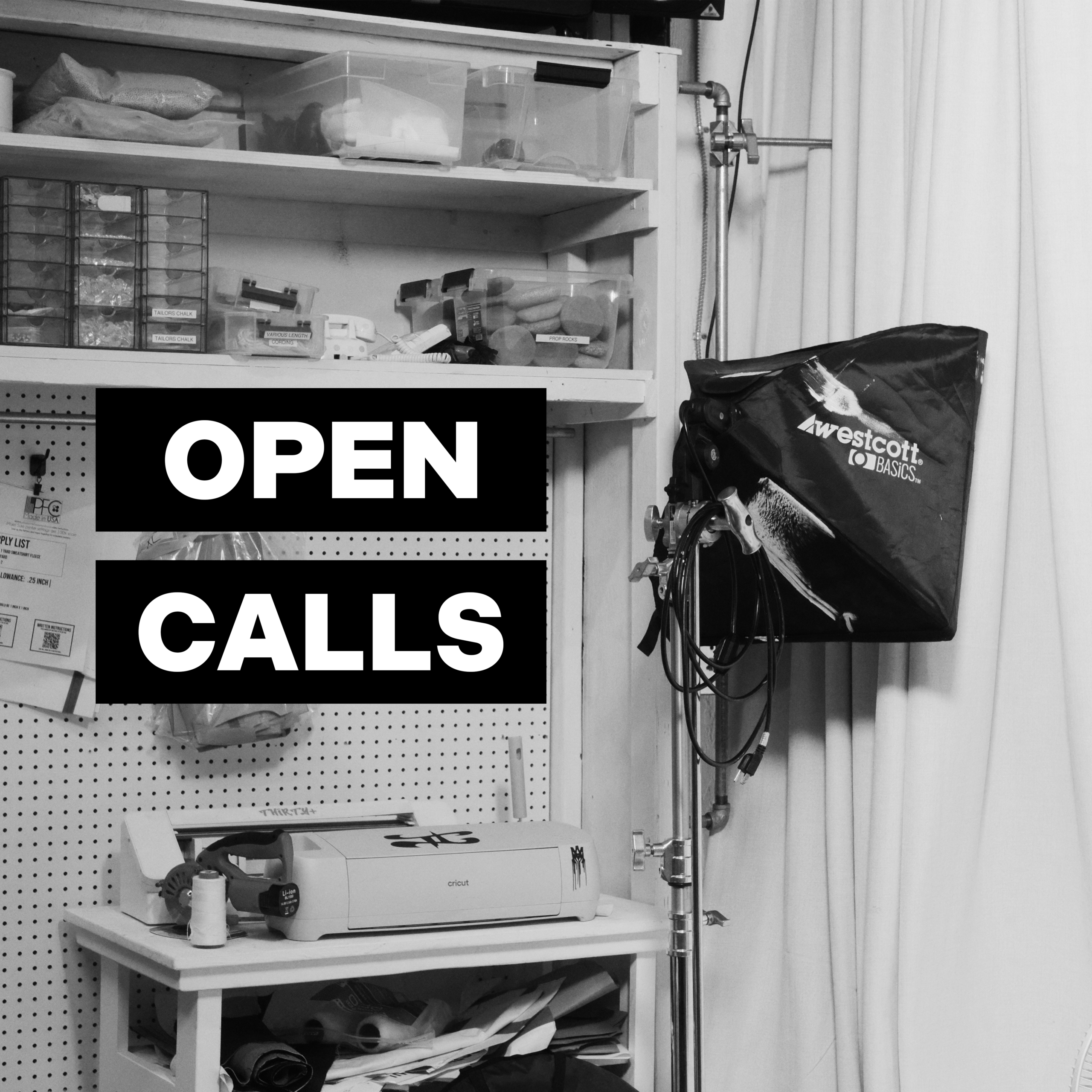 A photography studio workspace with storage shelves, lighting equipment, and bold text reading "OPEN CALLS" overlaid on the image.
